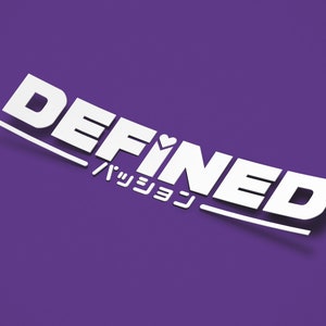 May include: White sticker with the word "DEFINED" in bold, sans-serif font, with a heart symbol above the "I". Below, Japanese characters are printed. The sticker is on a purple background.