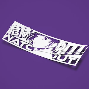 Peut inclure: Autocollant blanc avec une illustration en noir et blanc d'un visage de femme et le texte "ATTENTION!" en caractères japonais.