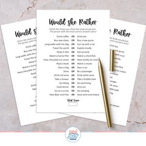May include: Three white paper sheets with the text "Would she Rather" printed in black. The game asks questions like "Drink coffee OR Drink tea?" A gold pen rests on the papers.