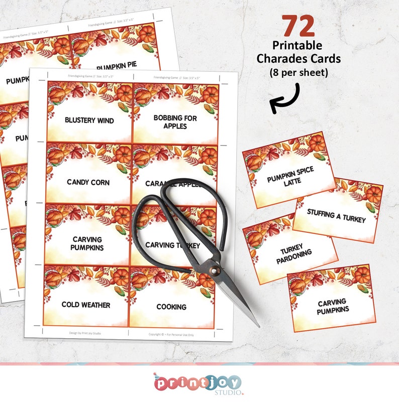 May include: A set of 72 printable charades cards on sheets with autumn-themed borders featuring pumpkins, leaves, and corn. The cards include text such as Blustery Wind, Bobbing for Apples, and Turkey Pardoning. A pair of black metal scissors rests on top.