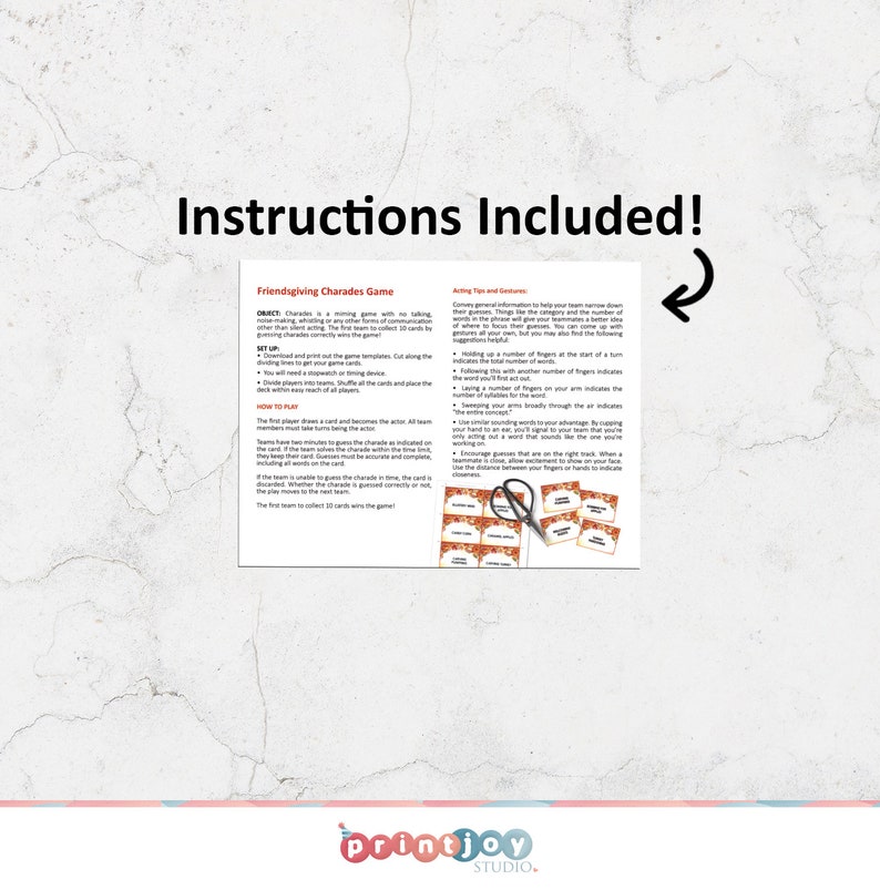May include: A printed sheet titled Friendsgiving Charades Game with instructions, acting tips, and a set of small orange-bordered cards featuring text. A pair of black scissors rests on top of the cards, and a curved arrow points to the text.