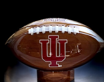 Own your very own custom solid cedar wooden football with your favorite team logo on it.