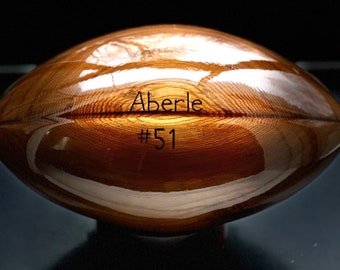 Engraved custom solid cedar wooden football with your favorite team logo.