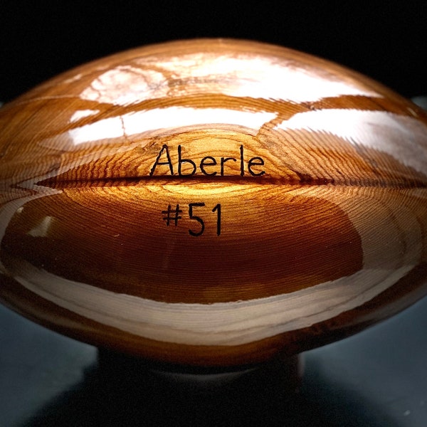 Engraved custom solid cedar wooden football with your favorite team logo.