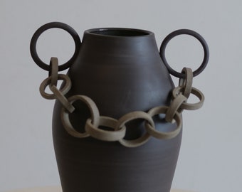 Black vase with chain