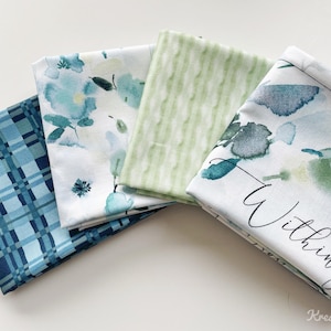May include: Four fabric swatches in shades of blue and green. One has a plaid pattern, another features watercolor floral designs, a third has vertical stripes, and the last has watercolor floral designs with the text "Within you".