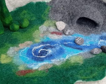 Large felt playmat with cave, meadow, river, stones, bushes, hay for the animals and two fir trees