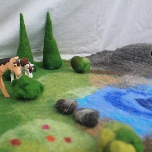 Fairy and flower felt landscape, a large felt play mat with a cave, meadow, river, stones, bushes, hay for the animals and two fir trees