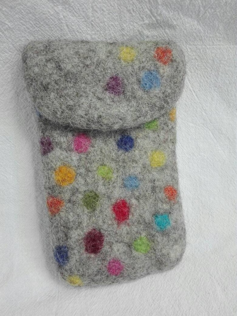 May include: A gray felt pouch with a flap closure. The pouch is decorated with colorful polka dots.