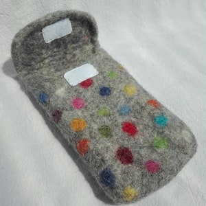 May include: A gray felt phone case with colorful polka dots. The case has a flap that closes with a velcro closure.