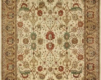 May include: A cream-colored rug with a detailed floral pattern in shades of red, green, and brown. The rug has a border with a repeating pattern of stylized flowers and leaves.