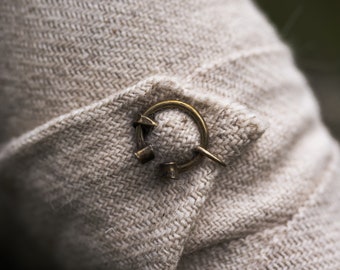 Pair of miniature penannular brass brooches with cilindrical terminals 9-13th. centutry. Two small brooches for winingas.