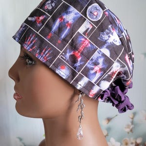 May include: A black scrub hat with a pattern of x-ray images of bones and joints. The hat has a purple tie at the back.