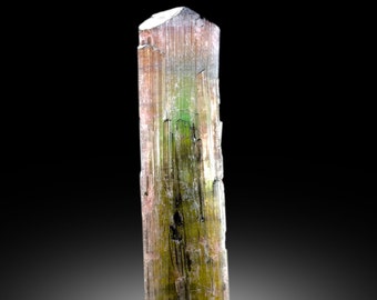 May include: A green and brown crystal with a striated surface. The crystal is translucent and has a slightly metallic sheen.