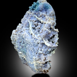 May include: A large, irregularly shaped, light blue and white agate with a bubbly texture. The agate has a smooth, polished surface and is a natural stone.