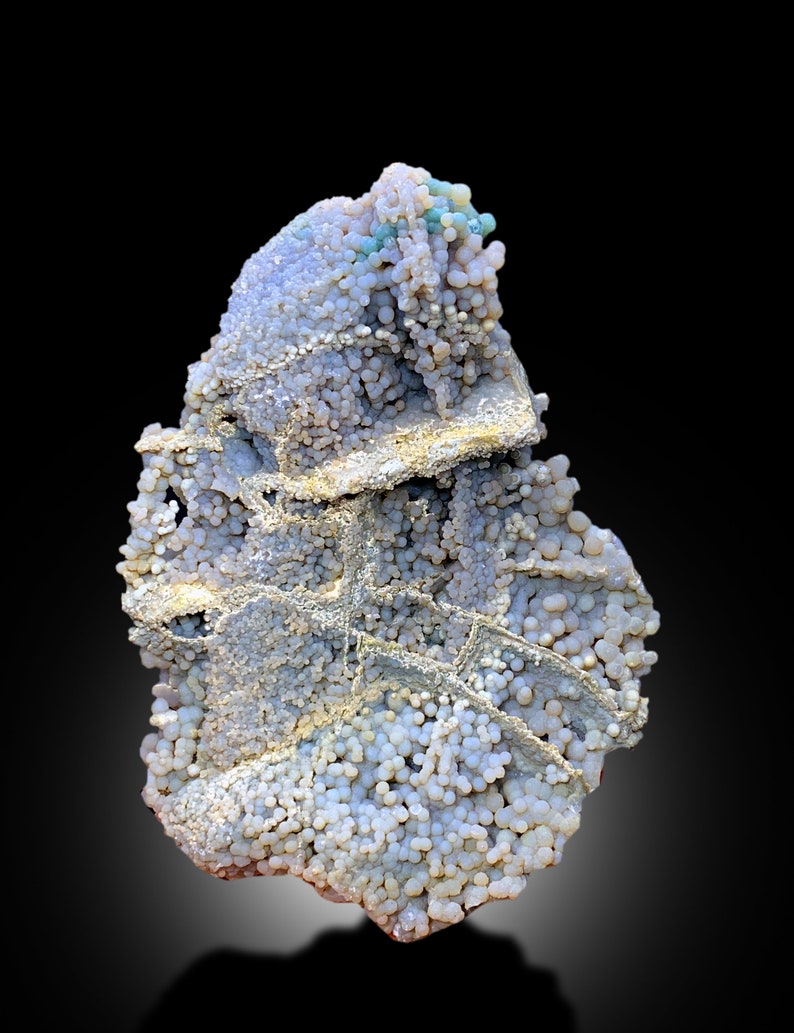 May include: A cluster of white, gray, and blue agate with a botryoidal texture. The agate has a rough, uneven surface and is covered in small, round nodules.
