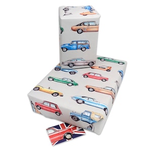 May include: A sheet of wrapping paper featuring a vintage car design. The paper is white with a variety of colourful cars printed on it. The cars are all different makes and models, and they are all drawn in a cartoon style. The paper is ideal for wrapping gifts for car enthusiasts.
