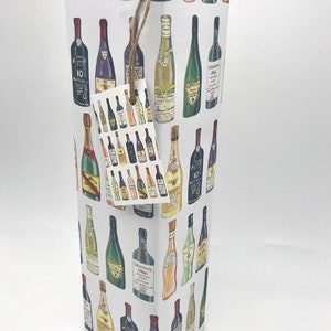 May include: White gift wrap with a repeating pattern of colorful wine bottles. The bottles are drawn in a cartoon style and include labels with text like "Barolo Gran Bussia" and "Graham's 1966 Vintage Port".