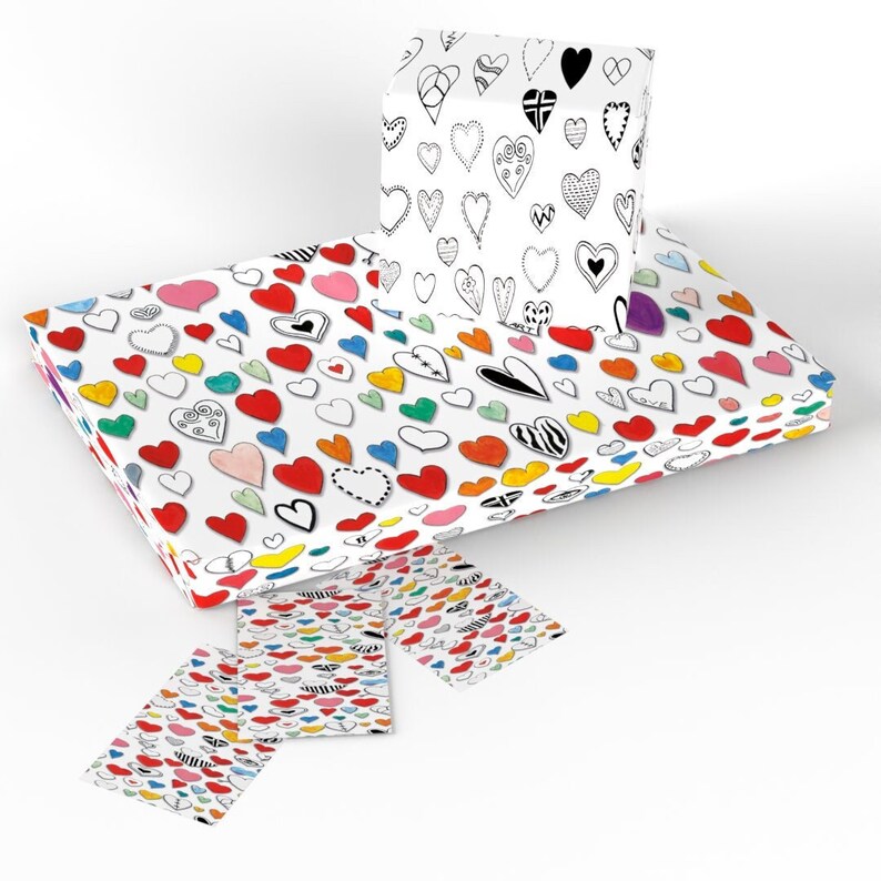May include: A set of colorful wrapping paper featuring a repeating pattern of hearts in various colors and styles. The paper is white with black outlines around the hearts. The set includes a small gift box wrapped in the same paper.