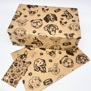 May include: Brown paper gift wrap with a repeating pattern of black dog silhouettes. The dogs are of various breeds and sizes, and the pattern also includes paw prints and bone shapes.