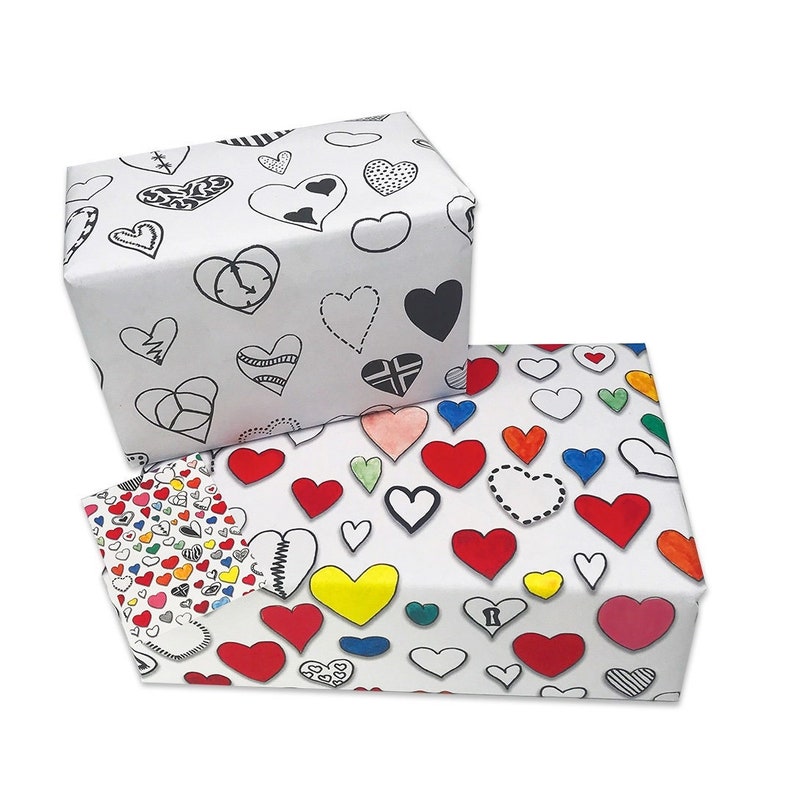 May include: Two gift wrap sheets with a white background and a pattern of black and white hearts. One sheet has colorful hearts with black outlines.
