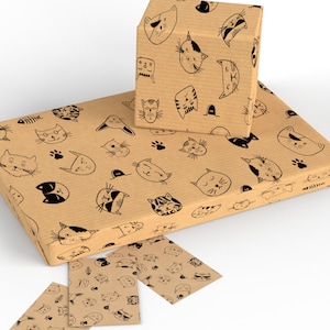 May include: Brown wrapping paper with a repeating pattern of black cat faces. The paper is rolled up and there are two smaller pieces of the same paper.