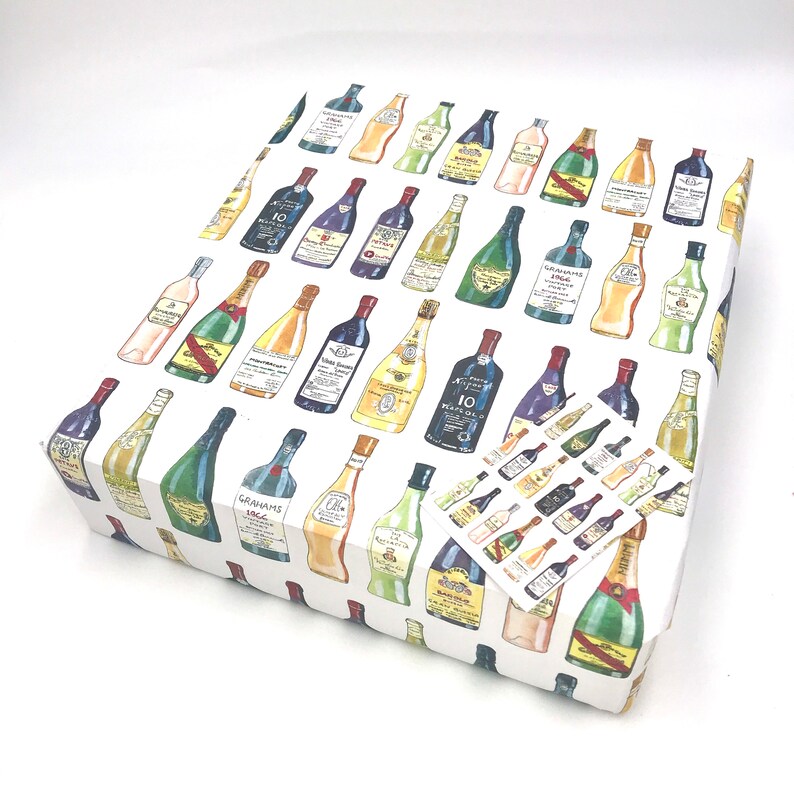 May include: White gift wrapping paper with a repeating pattern of colorful wine bottles. The bottles are drawn in a cartoon style and feature various labels with text.