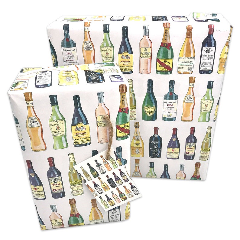 May include: White wrapping paper with a repeating pattern of colorful wine bottles. The bottles are drawn in a cartoon style and include red wine, white wine, champagne, and other types of alcohol. The paper includes a small gift tag with a similar pattern.