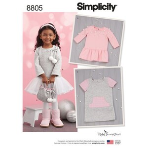 May include: A Simplicity sewing pattern for a girl's dress. The pattern includes three different styles: a pink dress with a ruffled hem and white pom-poms, a gray dress with a pink plaid pocket, and a gray dress with a white tulle skirt. The pattern is for sizes 8805.