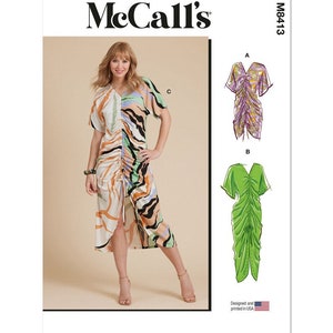 May include: McCall's sewing pattern M8413 for a dress with a gathered bodice and a front slit. The pattern includes three variations: a short-sleeved dress with a colorful abstract print, a sleeveless dress with a purple floral print, and a short-sleeved dress with a solid green color.