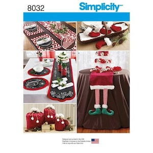 May include: A red and white elf table runner with a black and white patterned border. The table runner is on a brown tablecloth. The table runner is decorated with a red and white elf figure. The table runner is 8032 Simplicity.