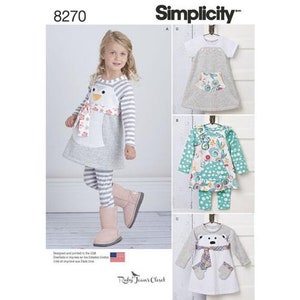 May include: A sewing pattern for children's clothing. The pattern includes three different designs: a penguin dress, a floral dress, and a polar bear dress. The pattern is from Simplicity and is number 8270.