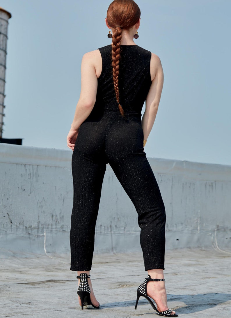 May include: A woman wearing a black sparkly jumpsuit with a braided ponytail and black high-heeled shoes.