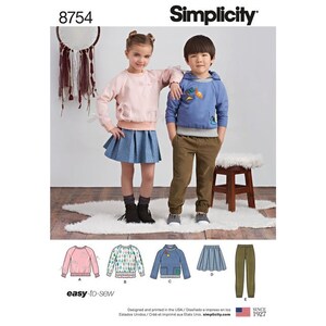May include: A sewing pattern for children's clothing, Simplicity pattern number 8754. The pattern includes instructions for making a pink sweatshirt, a blue sweatshirt with a white and green pattern, a blue sweatshirt with a pocket, a blue skirt, and green pants. The pattern is labeled "easy-to-sew".
