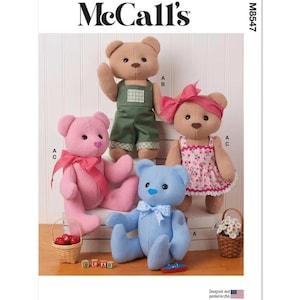 May include: McCall's M8547 sewing pattern envelope featuring four plush teddy bears. One bear is pink with a bow, one is tan in green overalls, one is tan in a floral dress with a pink bow, and one is light blue with a checkered bow. Includes small baskets.