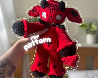 May include: A handmade red and black crochet doll with horns, large eyes, and a star-shaped belly. The doll has black accents on the ears, hands, and feet. The text "PDF pattern" is overlaid on the image.