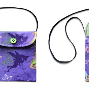 May include: Purple fabric purse with a flap closure and a green button. The purse has a black adjustable strap and features a print of fairies and flowers. The inside of the purse is lined with a light green fabric.