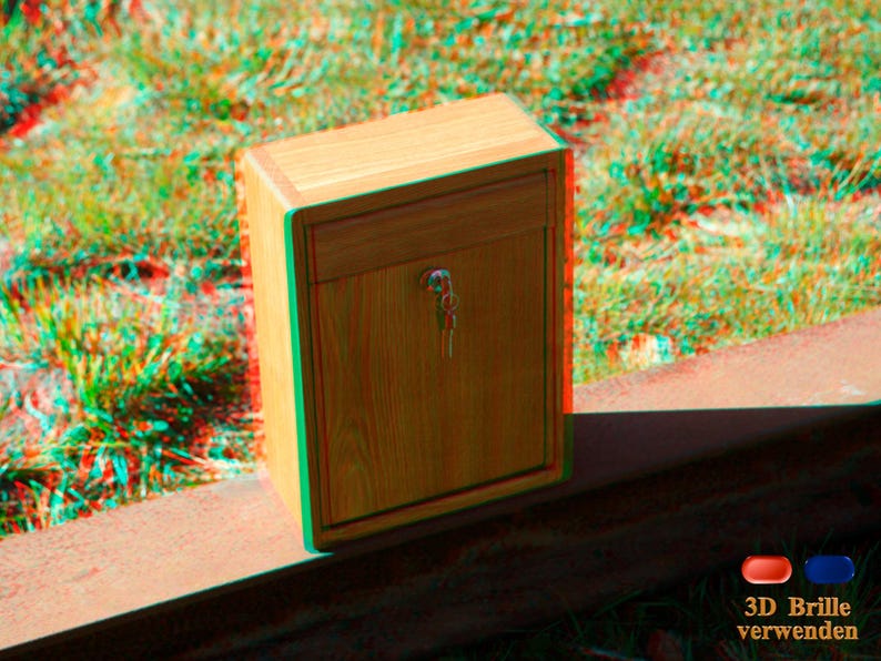 May include: A wooden box with a drawer and a keyhole. The box is sitting on a red surface. The text "3D Brille verwenden" is visible in the lower right corner of the image.