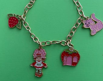Strawberry Shortcake w/house, cat & strawberry charm bracelet on 8.5” adj chain.
