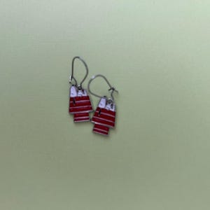 Snoopy Peanuts cartoon character on red roof doghouse drop earrings on hook wires. Comes with drawstring pouch-not pictured. USPS ground.