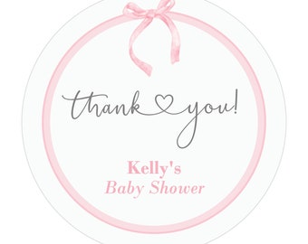 May include: Round pink and white thank you sticker with a pink bow and the text "Thank you! Kelly's Baby Shower"