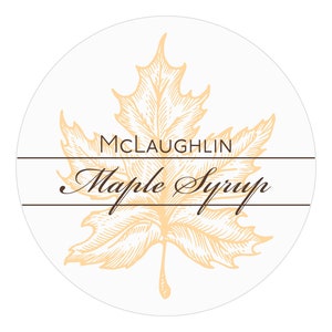 May include: A round label with a brown maple leaf design. The label reads "MCLAUGHLIN Maple Syrup".