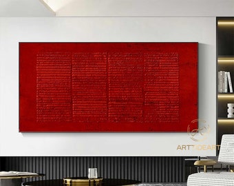 May include: Abstract red and gold painting with a textured surface. The painting is hanging on a white wall in a modern living room setting.