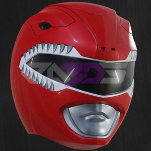 Op de afbeelding: Een rode Power Ranger helm met een zilveren mond en vizier. De helm heeft witte, tandachtige details rond het vizier en een strak ontwerp. De helm heeft een helderrode kleur.