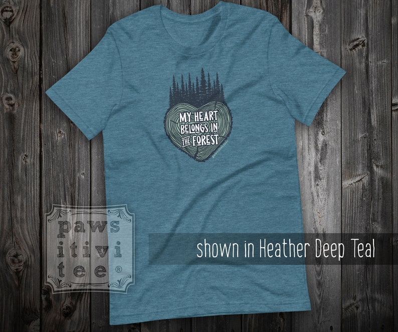 May include: A teal blue t-shirt with a tree-shaped heart graphic and the text "My heart belongs in the forest".