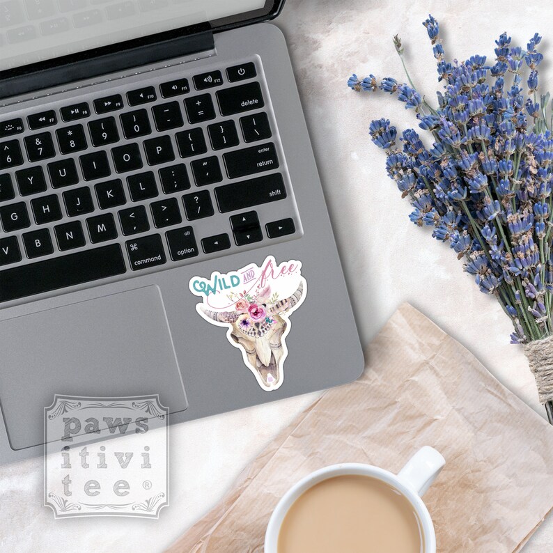 May include: A sticker with a cow skull decorated with flowers and the text "Go Wild and Free".