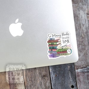 May include: A die-cut sticker featuring a stack of colorful books with the text So Many Books SO LITTLE TIME. The illustration includes a pair of glasses, a vintage alarm clock, and a sprig of purple lavender flowers at the base of the book stack.