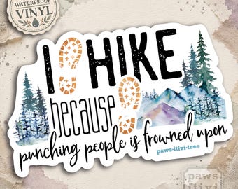 May include: A die-cut vinyl sticker featuring the text I HIKE because punching people is frowned upon in black lettering. The design includes two orange boot prints, watercolor-style evergreen trees, and blue and purple mountain peaks.