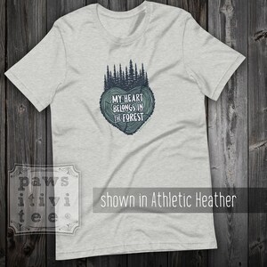 May include: A heather grey t-shirt with a forest green graphic of a tree stump heart with the text "My heart belongs in the forest".