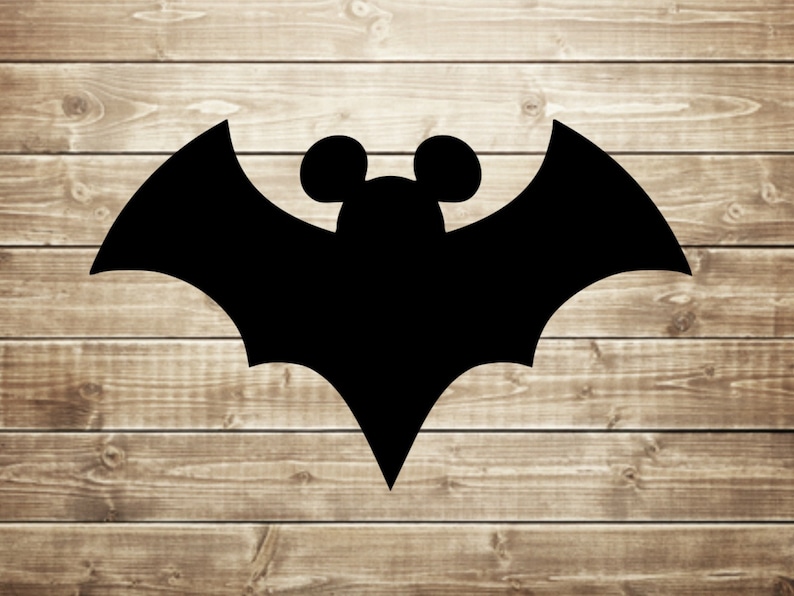 May include: Black silhouette of a bat with Mickey Mouse ears against a woodgrain background.